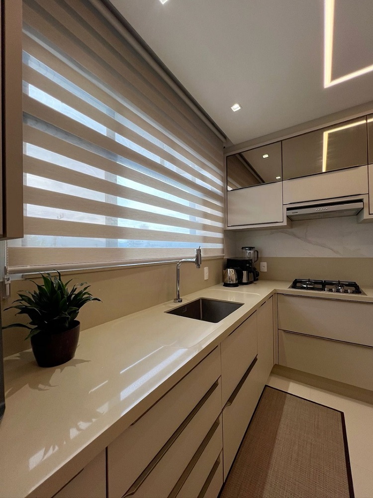 Modern kitchen featuring custom roller shades with alternating light-filtering fabric stripes, providing privacy, natural light control, and a sleek contemporary finish.