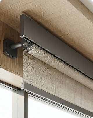 Close-up of a roller shades manufacturer installation featuring a charcoal-finish mounting bracket and operating mechanism.